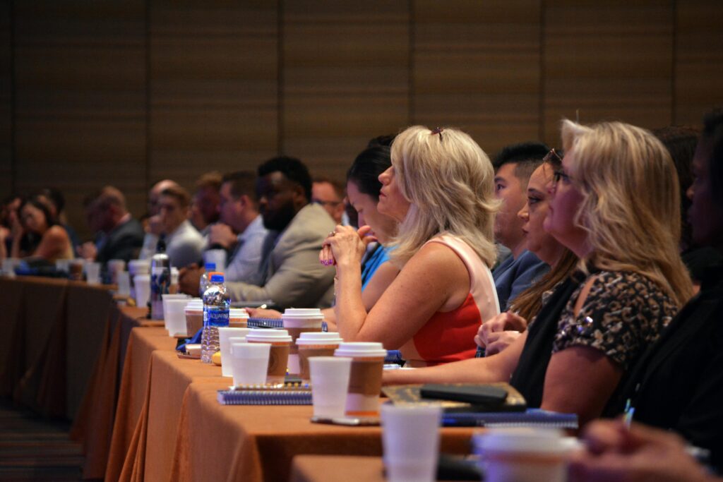 pexels-photo-3678057-3678057 Diverse group of business professionals attentive during a conference session in a meeting room.